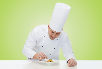 Image showing happy male chef cook decorating dish
