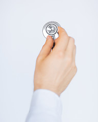 Image showing doctor hand with stethoscope listening somebody