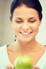 Image showing lovely housewife with green apple