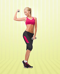 Image showing young sporty woman with dumbbells