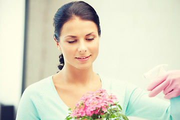 Image showing lovely housewife with flower