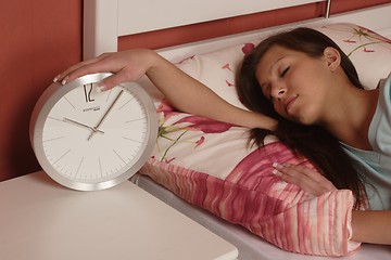 Image showing Young woman with clock