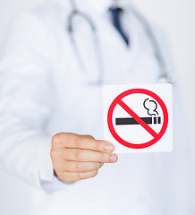 Image showing male doctor holding no smoking sign