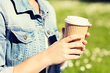 Image showing close up of young girl with coffee cup outdoors