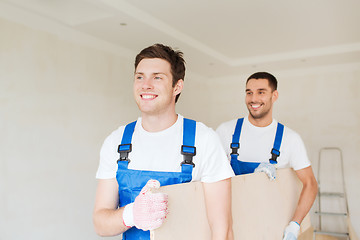 Image showing group of builders with wooden boards