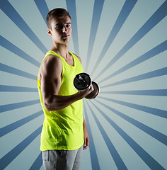 Image showing young man with dumbbell flexing biceps