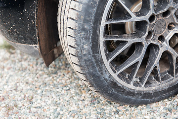 Image showing close up of dirty car wheel on ground