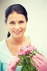 Image showing lovely housewife with flower