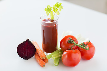 Image showing close up of fresh juice and vegetables on table