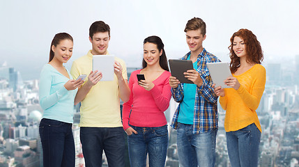 Image showing group of teenagers with smartphones and tablet pc