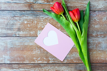 Image showing close up of tulips and greeting card with heart