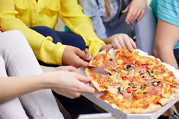 Image showing close up of happy friends eating pizza at home