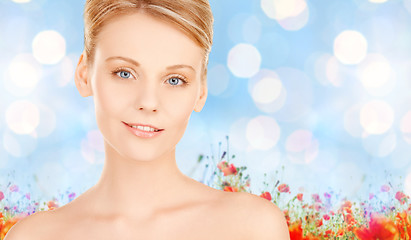 Image showing beautiful young woman face over blue background