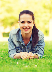 Image showing smiling young girl lying on grass