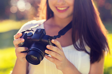 Image showing close up of young girl with photo camera outdoors