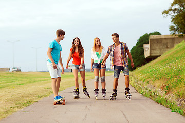 Image showing group of smiling teenagers with roller-skates