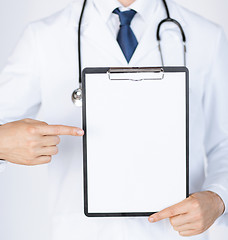 Image showing doctor pointing at blank white paper