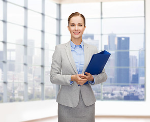 Image showing smiling businesswoman holding folder