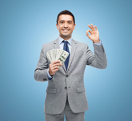 Image showing smiling businessman with american dollar money