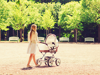 Image showing happy mother with stroller in park