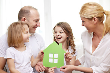 Image showing smiling parents and two little girls at new home