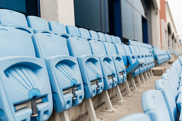 Image showing rows with folded seats of bleachers on stadium