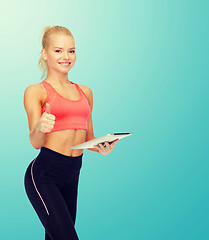 Image showing smiling sporty woman with tablet pc computer