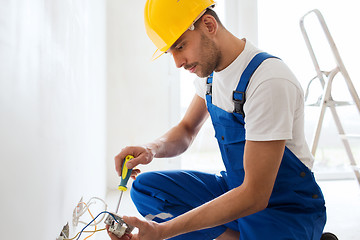 Image showing builder with tablet pc and equipment indoors