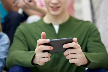 Image showing close up of young man with smartphone