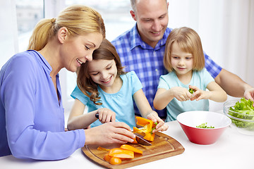 Image showing happy family with two kids cooking at home