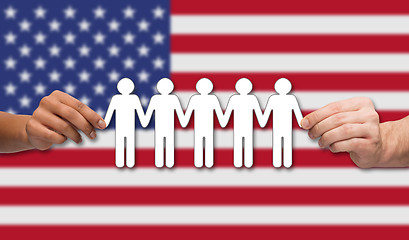 Image showing hands holding people pictogram over american flag