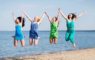 Image showing girls jumping on the beach