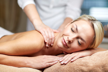 Image showing close up of woman lying and having massage in spa