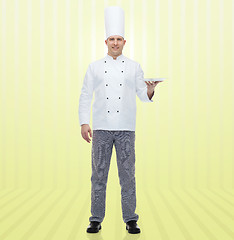 Image showing happy male chef cook showing empty plate