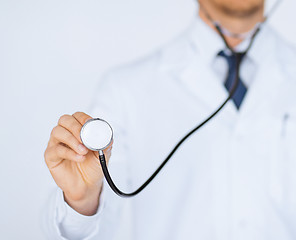 Image showing doctor hand with stethoscope listening something