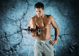 Image showing young man with dumbbell flexing biceps