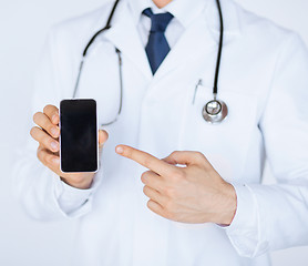 Image showing doctor pointing at smartphone