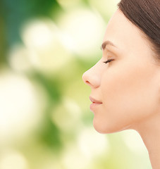 Image showing beautiful young woman face over green background