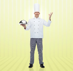 Image showing happy male chef cook holding cloche