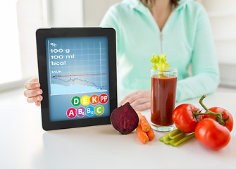 Image showing close up of woman with tablet pc and vegetables