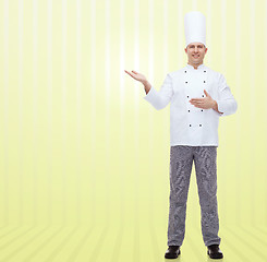 Image showing happy male chef cook inviting