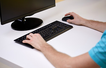 Image showing close up of male hands with computer and keyboard