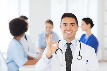 Image showing happy doctor over group of medics at hospital