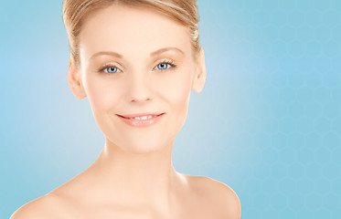 Image showing beautiful young woman face over blue background