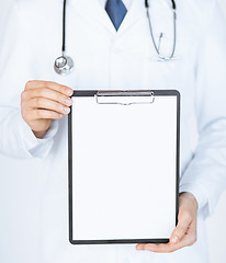 Image showing doctor holding blank white paper