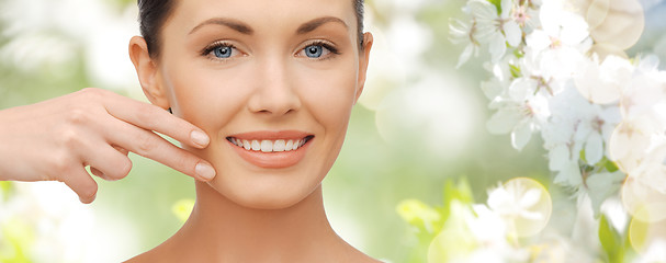 Image showing face and hand of smiling woman over summer garden