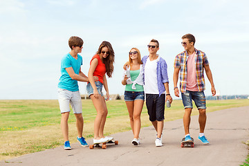 Image showing group of smiling teenagers with skateboards