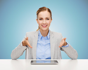 Image showing business woman with tablet pc sitting at table