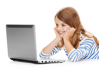 Image showing smiling student girl with laptop computer lying