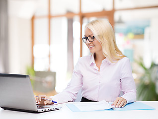 Image showing smiling businesswoman or student with laptop